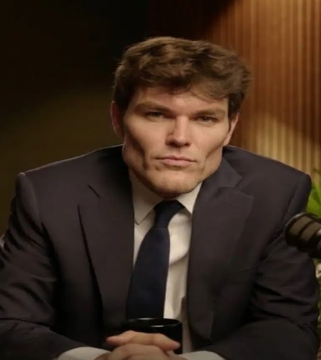 Nick Fuentes in a suit, presented in a satirical chad-style frame